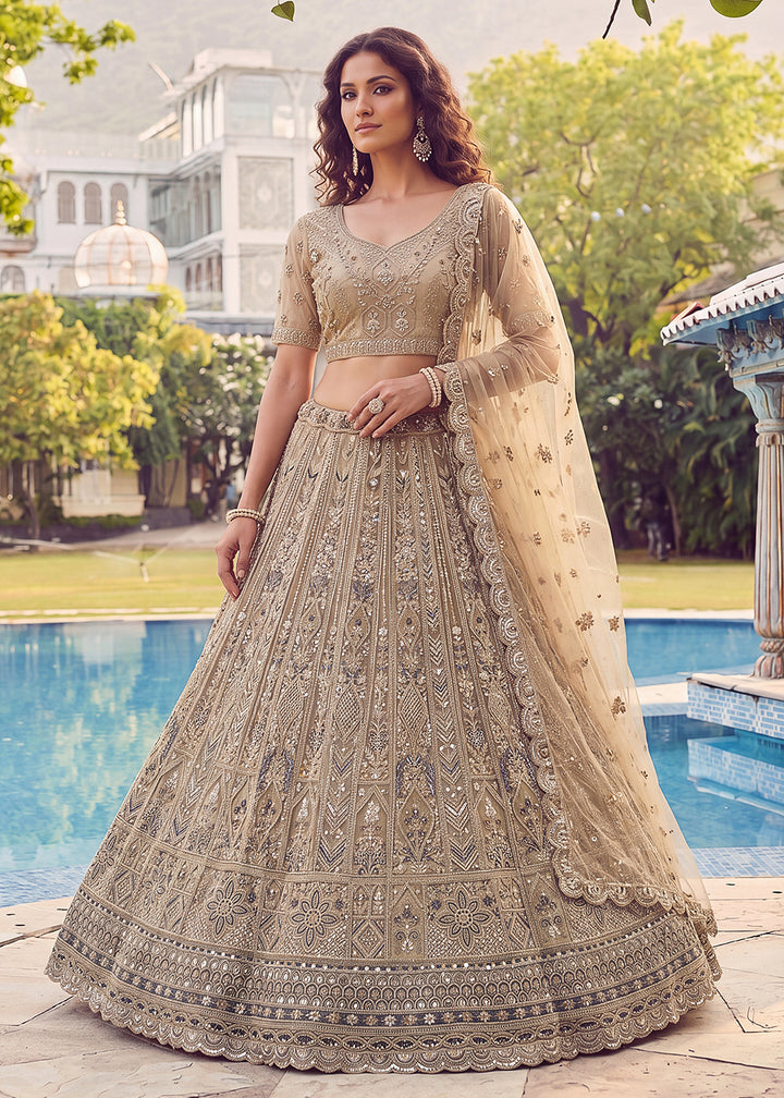 Buy Now Embroidered Dusty Gold Net Bridal Designer Lehenga Choli Online in US, UK, Canada, France, Italy, Germany, Sweden, UAE &amp; Worldwide at Empress Clothing.