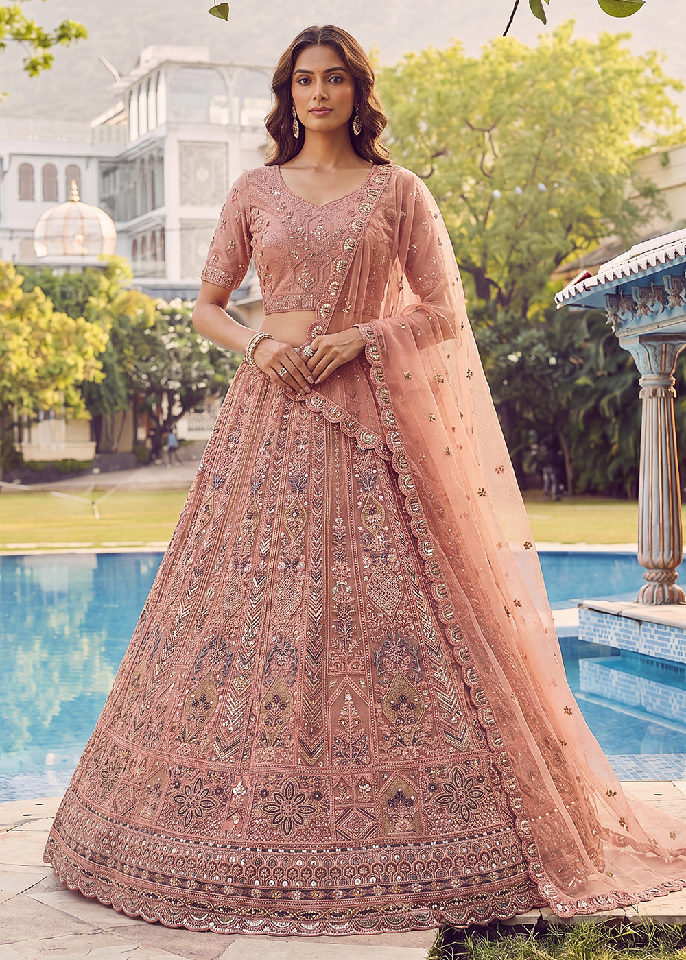 Buy Now Embroidered Peach Net Bridal Designer Lehenga Choli Online in US, UK, Canada, France, Italy, Germany, Sweden, UAE &amp; Worldwide at Empress Clothing.