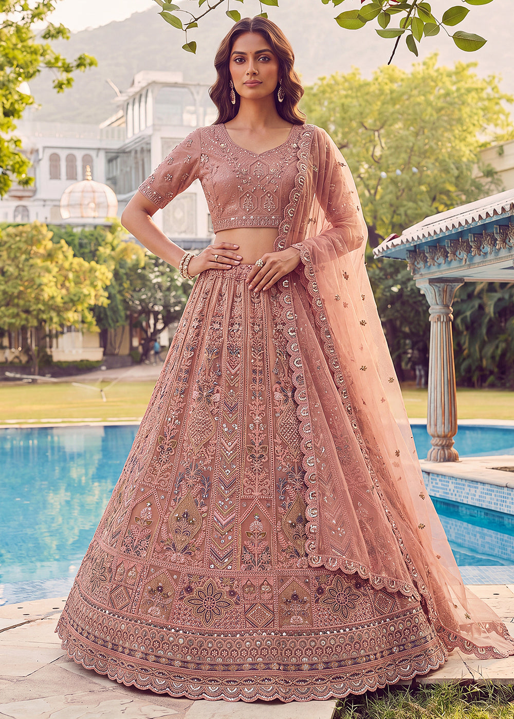Buy Now Embroidered Peach Net Bridal Designer Lehenga Choli Online in US, UK, Canada, France, Italy, Germany, Sweden, UAE &amp; Worldwide at Empress Clothing.