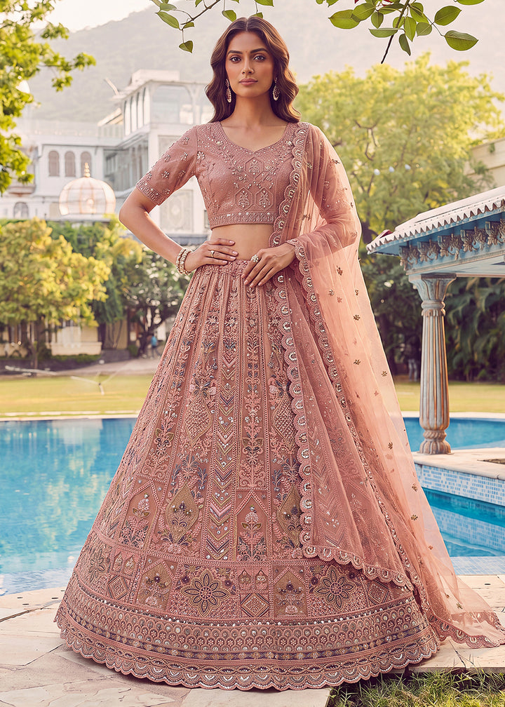 Buy Now Embroidered Peach Net Bridal Designer Lehenga Choli Online in US, UK, Canada, France, Italy, Germany, Sweden, UAE &amp; Worldwide at Empress Clothing.