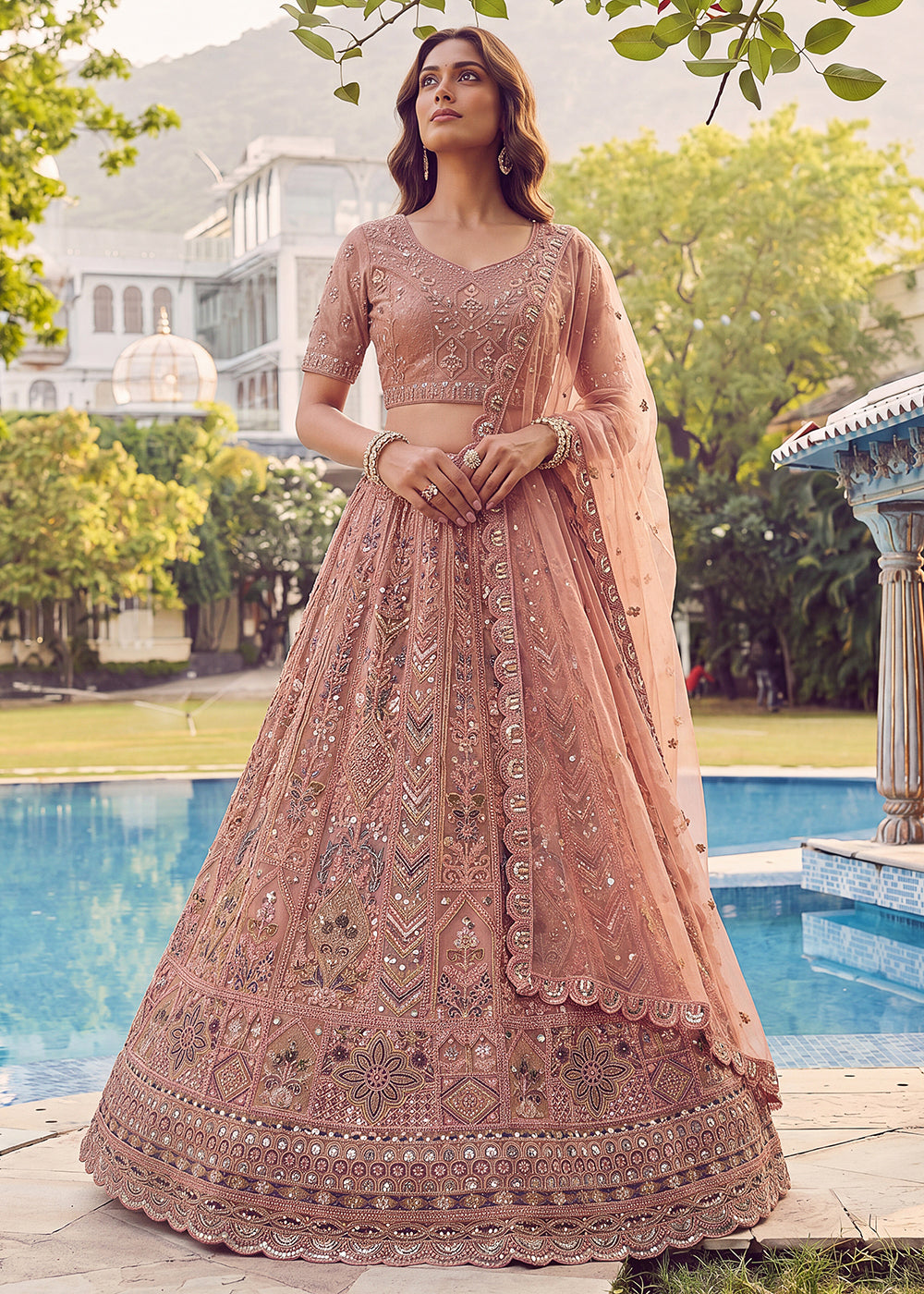 Buy Now Embroidered Peach Net Bridal Designer Lehenga Choli Online in US, UK, Canada, France, Italy, Germany, Sweden, UAE &amp; Worldwide at Empress Clothing.