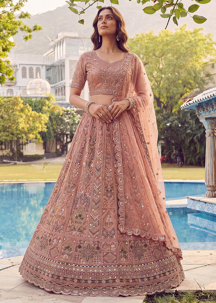 Buy Now Embroidered Peach Net Bridal Designer Lehenga Choli Online in US, UK, Canada, France, Italy, Germany, Sweden, UAE &amp; Worldwide at Empress Clothing.