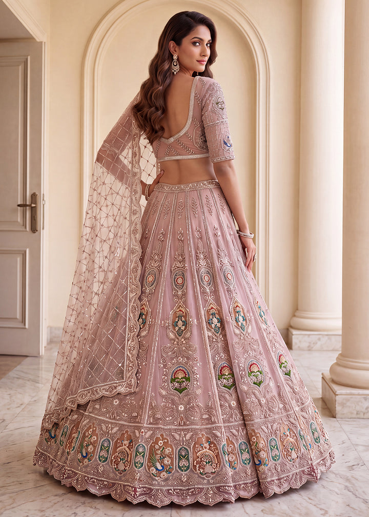 Buy Now Appealing Mauve Net Heavy Embroidered Bridal Lehenga Choli Online in US, UK, Canada, France, Italy, Germany, Sweden, Austria &amp; Worldwide at Empress.