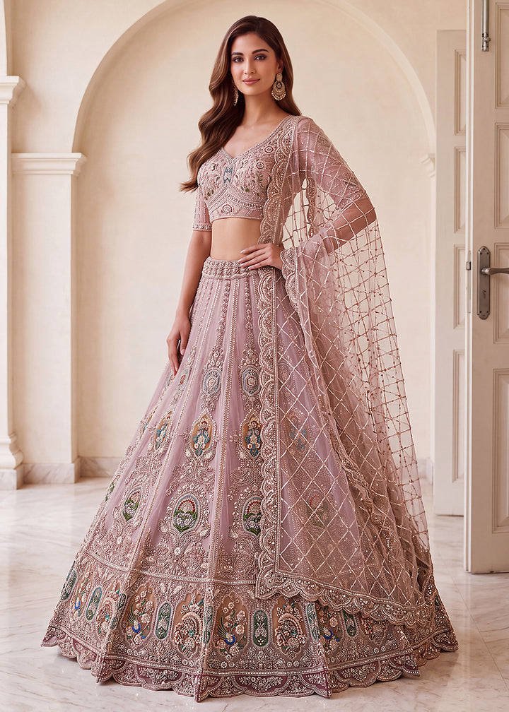 Buy Now Appealing Mauve Net Heavy Embroidered Bridal Lehenga Choli Online in US, UK, Canada, France, Italy, Germany, Sweden, Austria &amp; Worldwide at Empress.