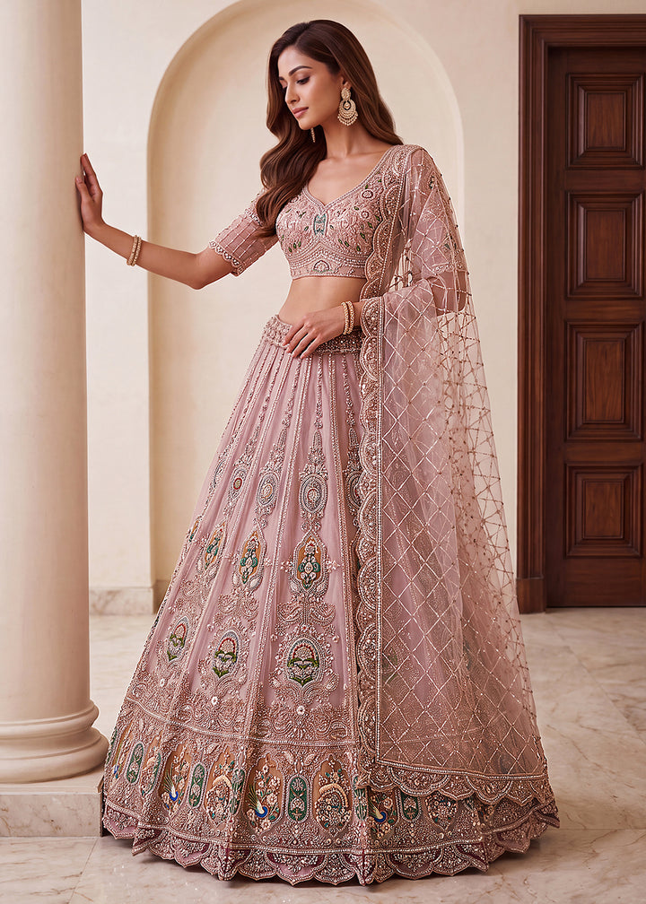 Buy Now Appealing Mauve Net Heavy Embroidered Bridal Lehenga Choli Online in US, UK, Canada, France, Italy, Germany, Sweden, Austria &amp; Worldwide at Empress.