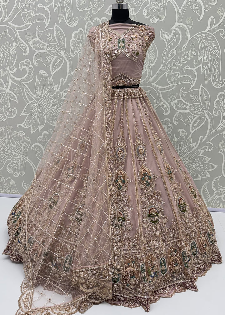Buy Now Appealing Mauve Net Heavy Embroidered Bridal Lehenga Choli Online in US, UK, Canada, France, Italy, Germany, Sweden, Austria &amp; Worldwide at Empress.