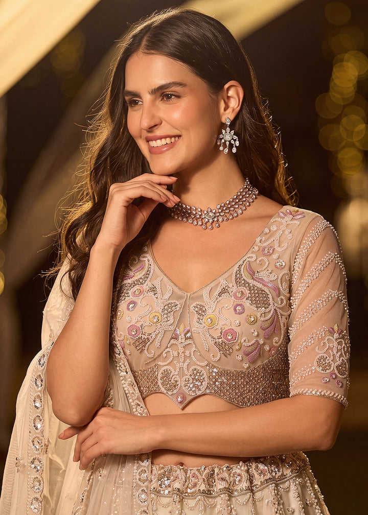 Shop Now Dreamy Cream Sheer-Sleeve Party Wear Lehenga Choli Online in USA, UK, Canada, France, Germany, Spain, Austria, Sweden, UAE &amp; Worldwide at Empress.