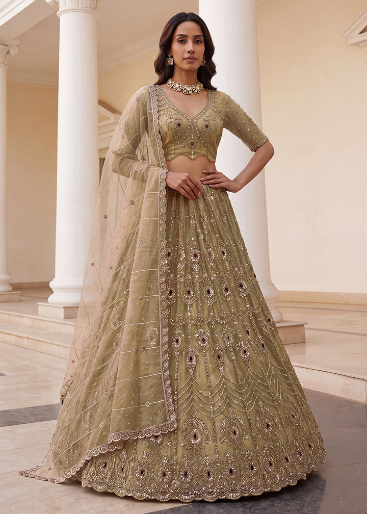 Shop Now Eye-catchy Chiku Ruby Stone Work Wedding Lehenga Choli Online in USA, UK, Canada, France, Germany, Austria, Australia, Italy &amp; Worldwide at Empress.