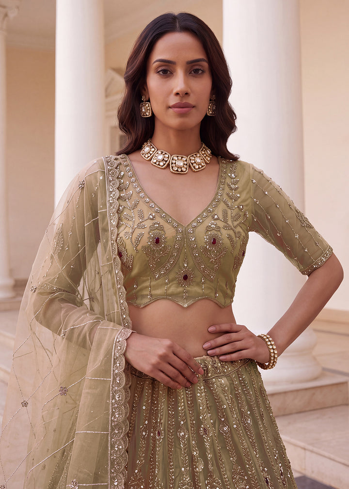 Shop Now Eye-catchy Chiku Ruby Stone Work Wedding Lehenga Choli Online in USA, UK, Canada, France, Germany, Austria, Australia, Italy &amp; Worldwide at Empress.