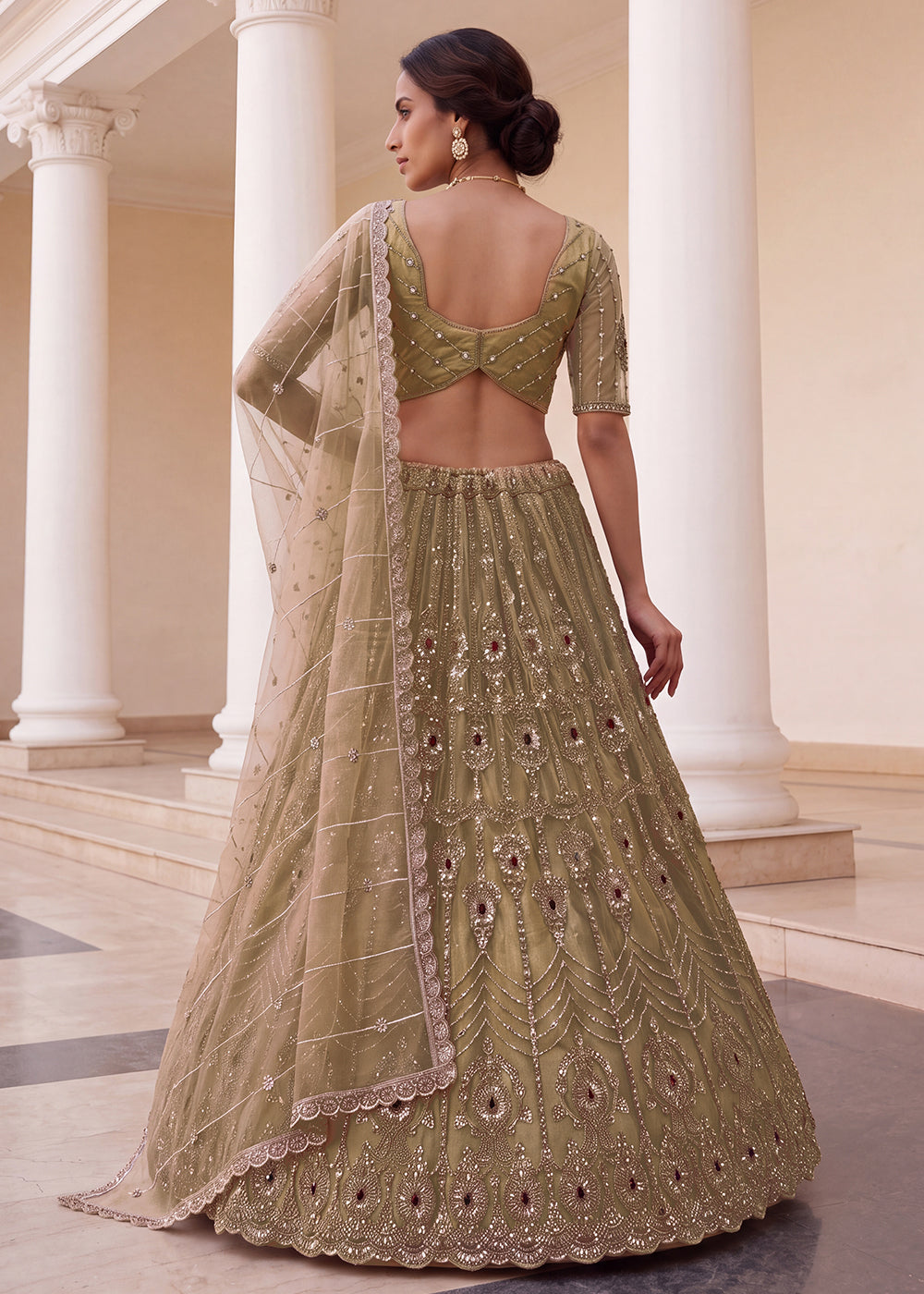 Shop Now Eye-catchy Chiku Ruby Stone Work Wedding Lehenga Choli Online in USA, UK, Canada, France, Germany, Austria, Australia, Italy &amp; Worldwide at Empress.