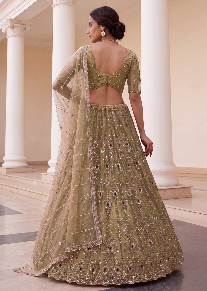 Shop Now Eye-catchy Chiku Ruby Stone Work Wedding Lehenga Choli Online in USA, UK, Canada, France, Germany, Austria, Australia, Italy &amp; Worldwide at Empress.
