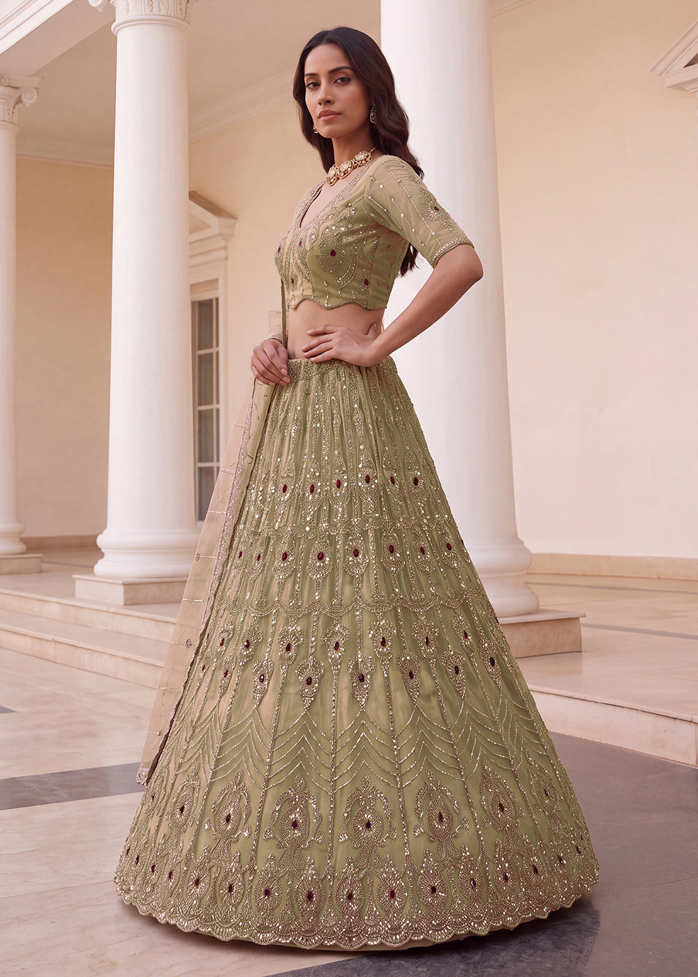 Shop Now Eye-catchy Chiku Ruby Stone Work Wedding Lehenga Choli Online in USA, UK, Canada, France, Germany, Austria, Australia, Italy &amp; Worldwide at Empress.