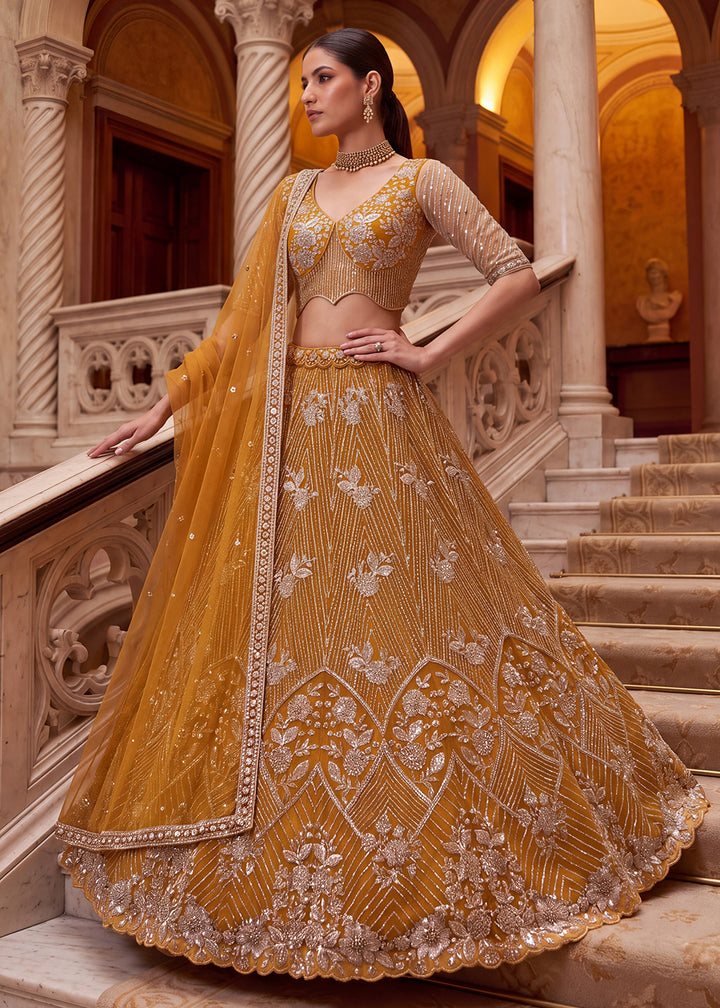 Shop Breathtaking Yellow Heavy Embroidery Reception Party Lehenga Choli Online in USA, UK, Canada, France, Germany, Spain, Austria, UAE &amp; Worldwide at Empress.