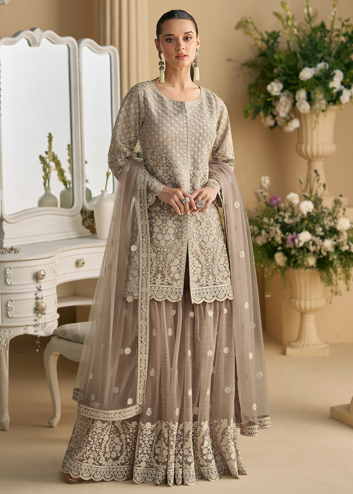 Buy Now Taupe Grey Net Chikankari Sharara Style Suit Online in US, UK, Canada, Germany, Italy, France, Austria, Denmark, UAE & Worldwide at Empress Clothing