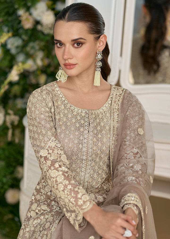 Buy Now Taupe Grey Net Chikankari Sharara Style Suit Online in US, UK, Canada, Germany, Italy, France, Austria, Denmark, UAE & Worldwide at Empress Clothing