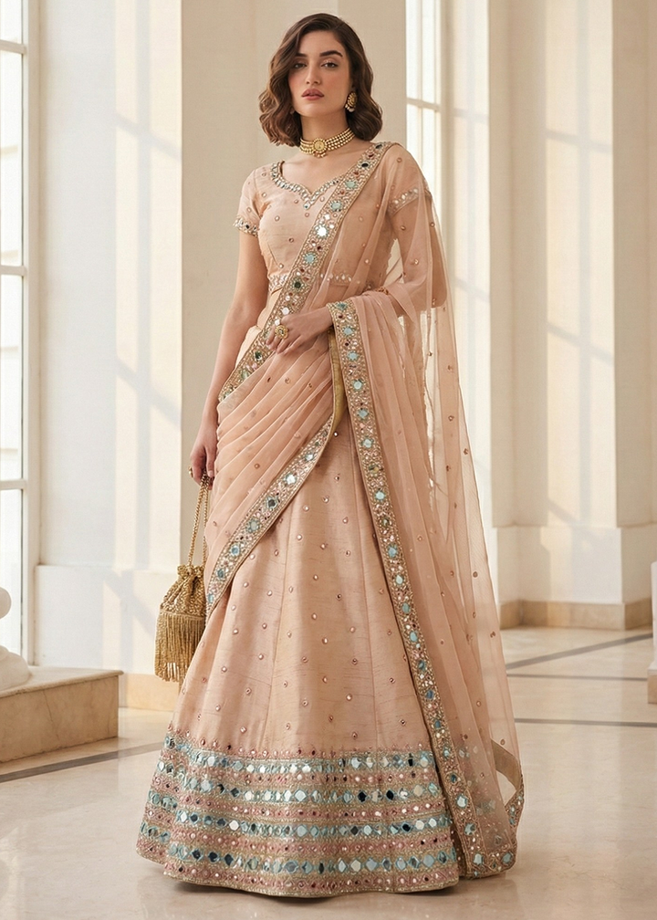 Buy Now Mirror Work Pastel Peach Wedding Wear Lehenga Online in US, UK, Canada, France, Germany, Sweden, Greece, Denmark, Spain, Africa & Worldwide at Empress.