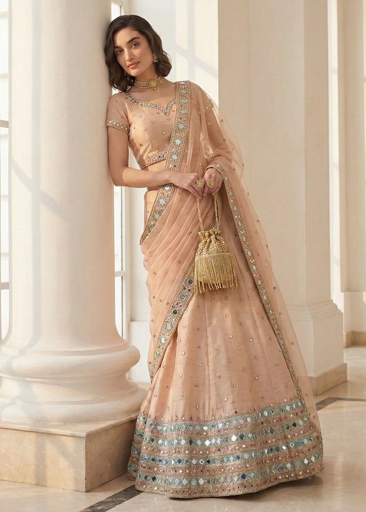 Buy Now Mirror Work Pastel Peach Wedding Wear Lehenga Online in US, UK, Canada, France, Germany, Sweden, Greece, Denmark, Spain, Africa & Worldwide at Empress.