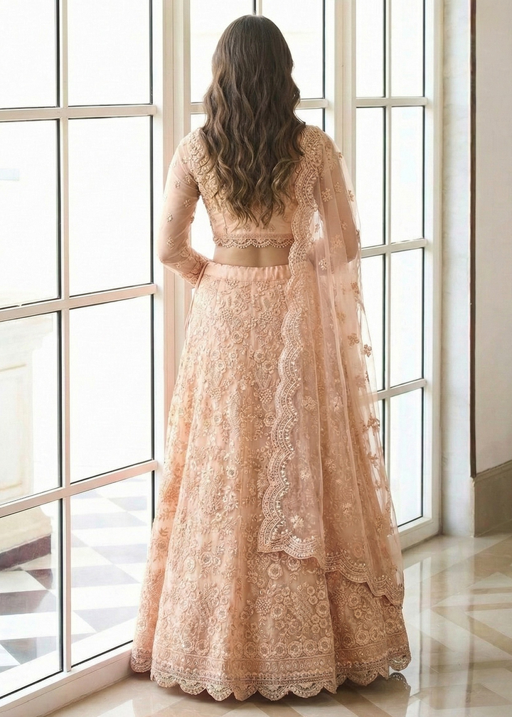 Buy Now Adorable Peach Heavy Net Embroidered Bridal Lehenga Choli Online in USA, UK, France, Italy, Germany, Sweden, Greece, Qatar, UAE & Worldwide at Empress.