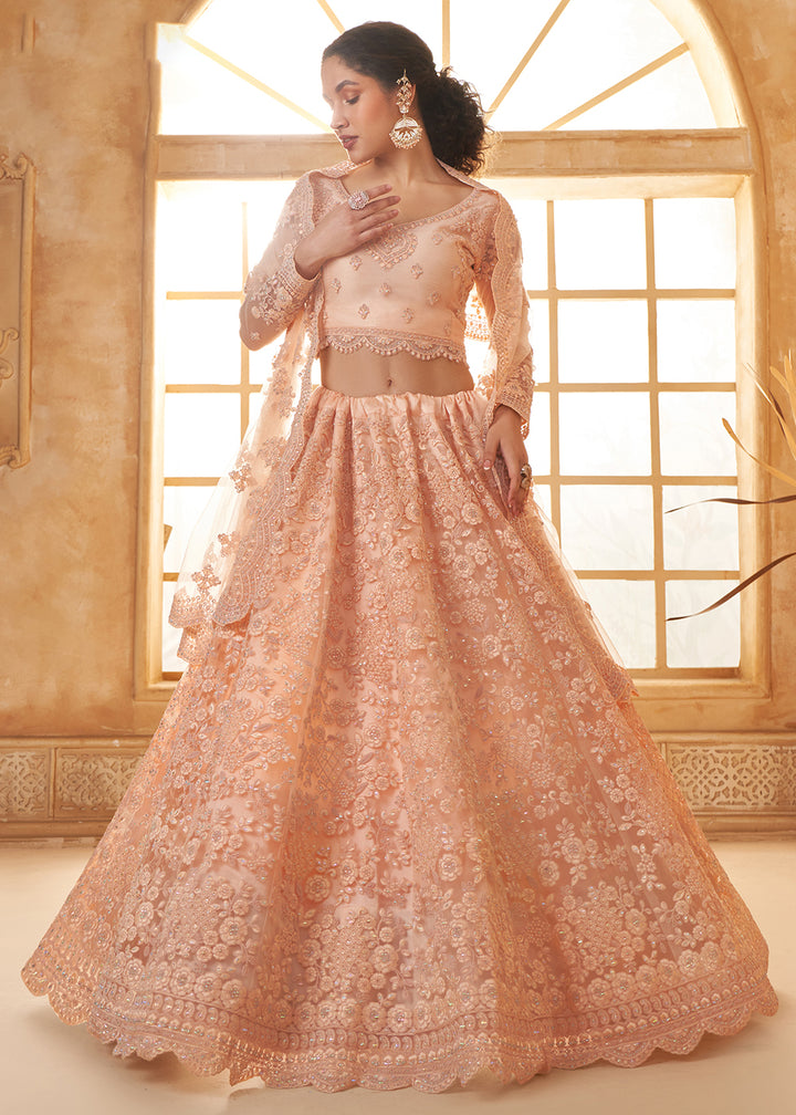 Buy Now Adorable Peach Heavy Net Embroidered Bridal Lehenga Choli Online in USA, UK, France, UAE & Worldwide at Empress Clothing.