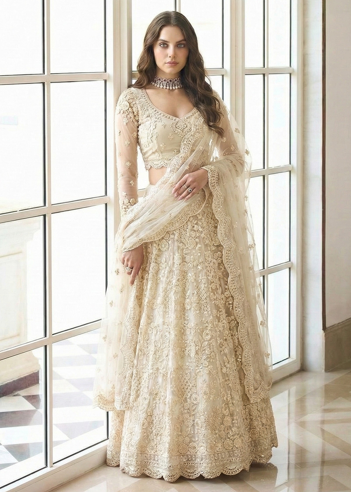 Buy Now Adorable Cream Heavy Net Embroidered Bridal Lehenga Choli Online in USA, UK, France, Swiss, Netherlands, Germany, Italy, Qatar & Worldwide at Empress.