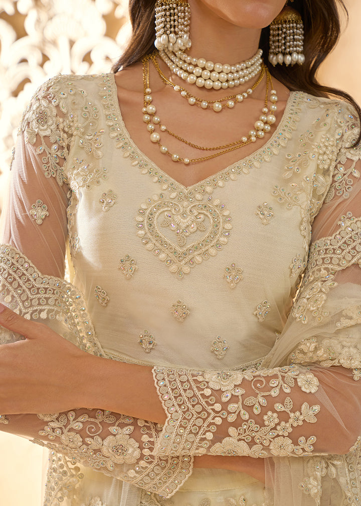 Buy Now Attractive Cream Heavy Net Embroidered Bridal Lehenga Choli Online in USA, UK, France, UAE & Worldwide at Empress Clothing. 