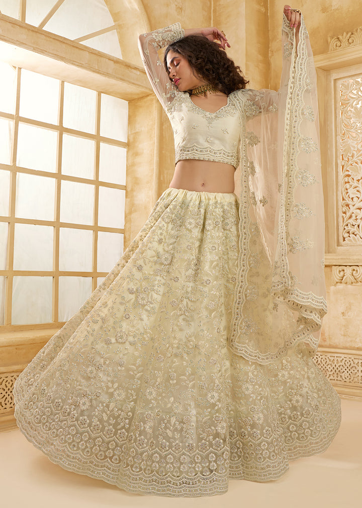 Buy Now Attractive Cream Heavy Net Embroidered Bridal Lehenga Choli Online in USA, UK, France, UAE & Worldwide at Empress Clothing. 