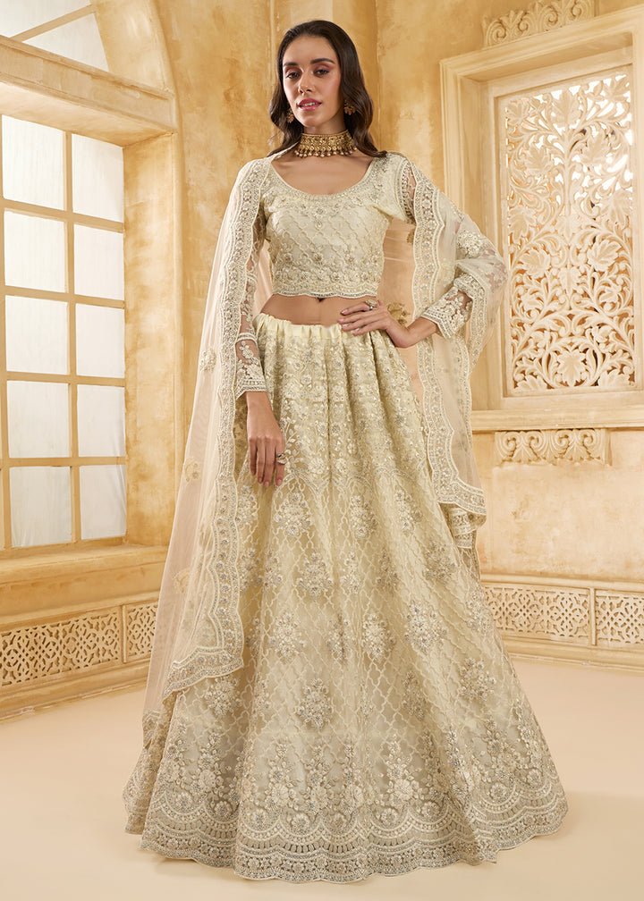 Buy Now Lovely Cream Heavy Net Embroidered Bridal Lehenga Choli Online in USA, UK, France, UAE & Worldwide at Empress Clothing. 