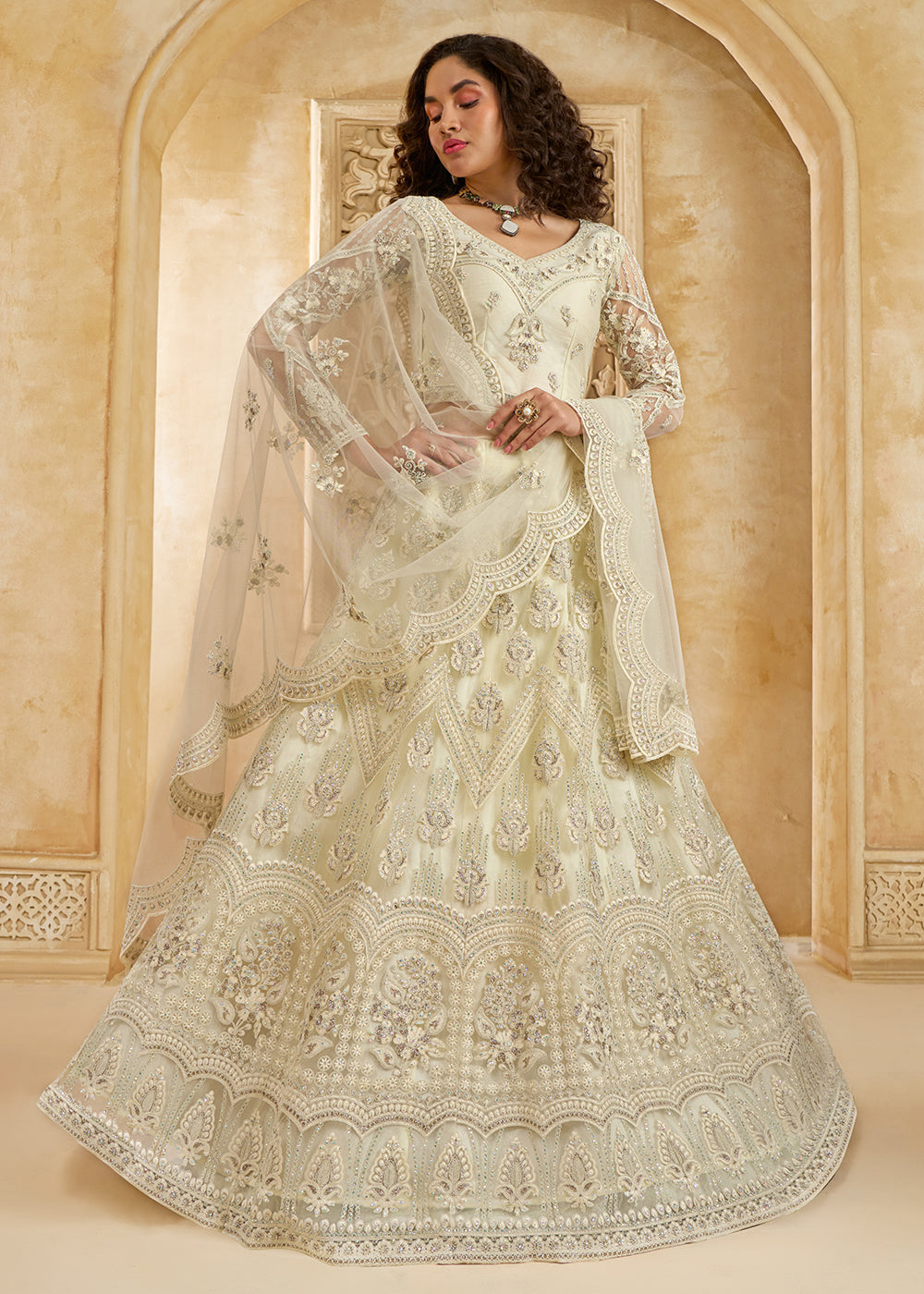 Buy Now Gorgeous Cream Heavy Net Embroidered Bridal Lehenga Choli Online in USA, UK, France, UAE & Worldwide at Empress Clothing.