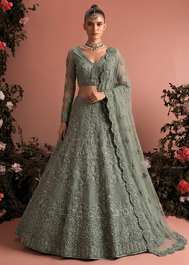 Buy Now Sage Green Butterfly Net Heavy Wedding Style Lehenga Choli Online in US, UK, Canada, France, Italy, Germany, Australia, Greece &amp; Worldwide at Empress.