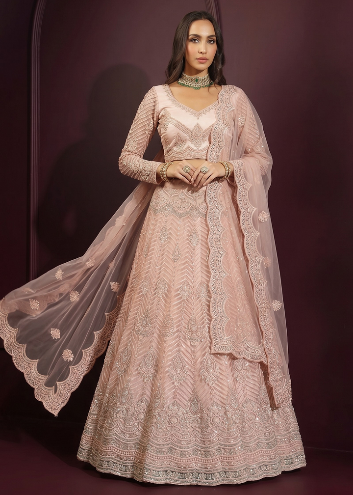 Buy Now Pinkish Peach Net Embroidered Bridesmaids Lehenga Choli Online in US, UK, Canada, France, Italy, Greece, Sweden, Netherlands, UAE &amp; Worldwide at Empress.