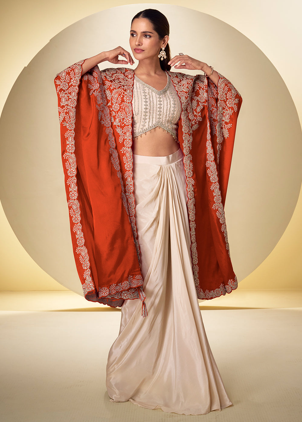 Buy Now Ivory Cream Dhoti Style Indo Western Dress with Orange Shrug Online in US, UK, Canada, Netherlands, Germany, Italy, France, Greece & Worldwide at Empress.