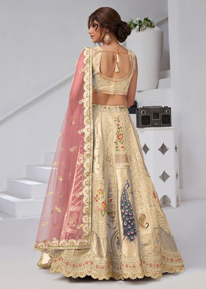 Buy Now Cream Peacock Feather Motifs Traditional Lehenga Choli Online in US, UK, Canada, France, Italy, Germany, Sweden, Denmark, Greece & Worldwide at Empress.