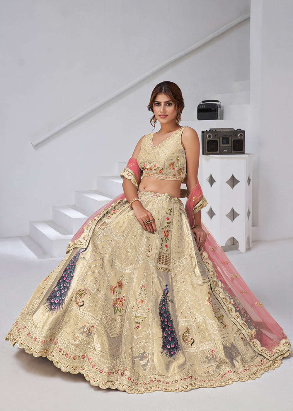 Buy Now Cream Peacock Feather Motifs Traditional Lehenga Choli Online in US, UK, Canada, France, Italy, Germany, Sweden, Denmark, Greece & Worldwide at Empress.