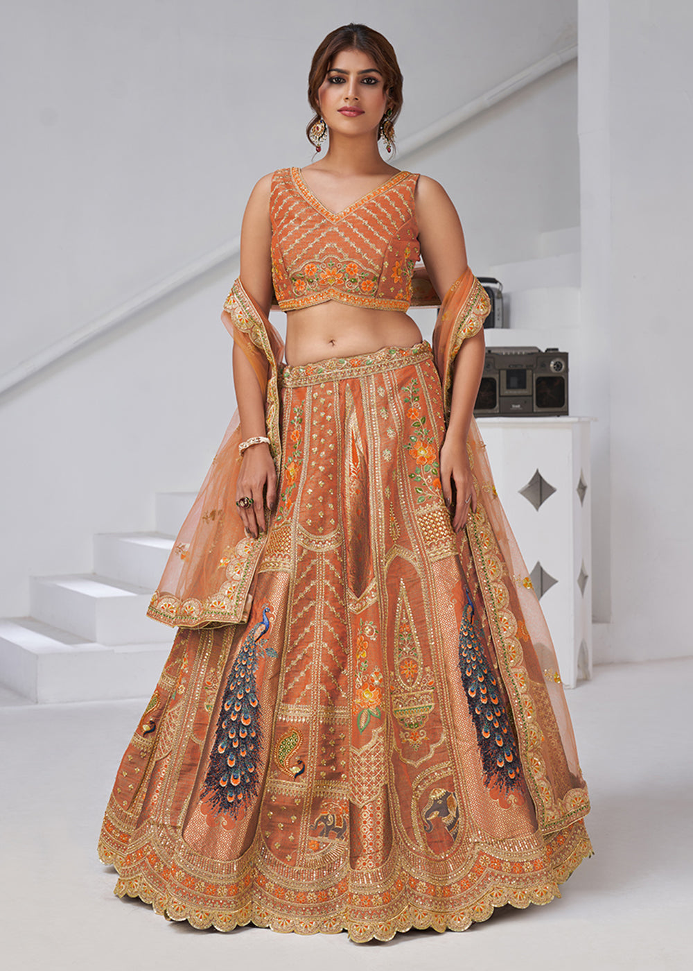 Buy Now Orange Peacock Feather Motifs Traditional Lehenga Choli Online in US, UK, Canada, France, Italy, Germany, Sweden, Denmark, Greece & Worldwide at Empress.