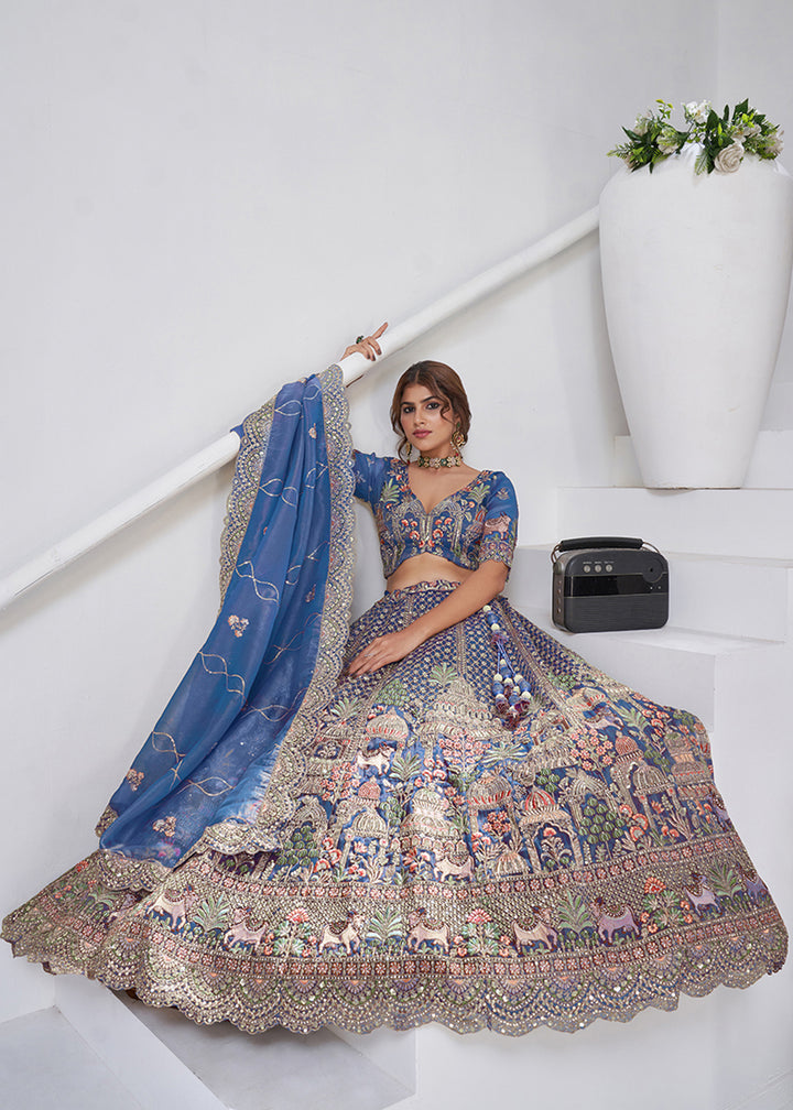 Buy Now Teal Blue Temple & Cow Motifs Bridal Lehenga Choli Online in US, UK, Canada, France, Germany, Sweden, Denmark, Greece, Ireland & Worldwide at Empress.