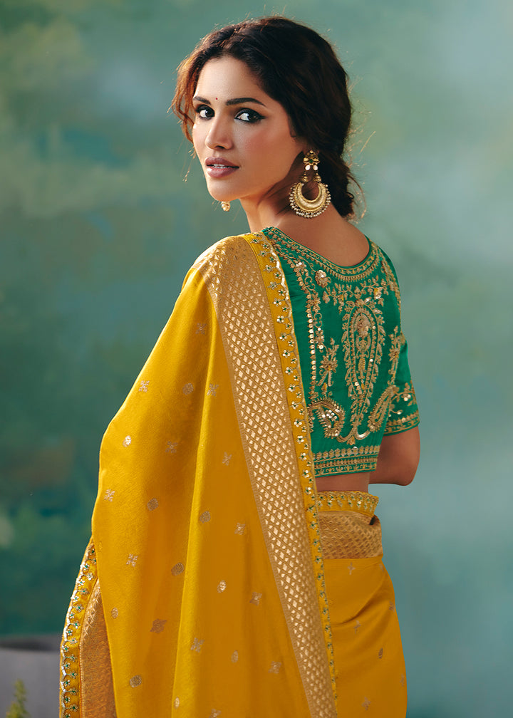 Buy Fancy Yellow Premium Dola Viscose Silk Wedding Wear Saree Online in US, UK, Canada, France, Germany, Denmark, Spain, Belgium, Sweden & Worldwide at Empress.