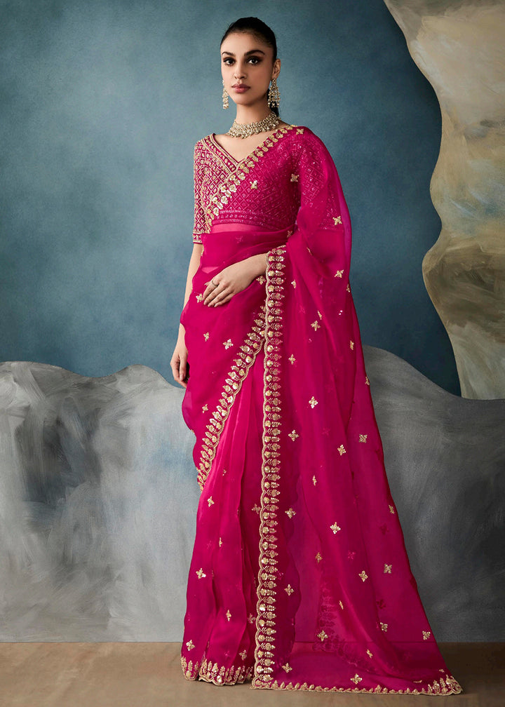 Radiant Rani Pink tissue saree with intricate handwork & cutwork embroidery. Includes matching blouse piece. Perfect for wedding & festivals. Shop Now.