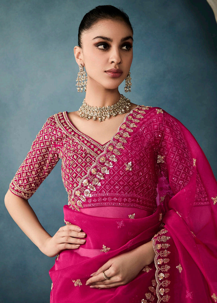 Radiant Rani Pink tissue saree with intricate handwork & cutwork embroidery. Includes matching blouse piece. Perfect for wedding & festivals. Shop Now.