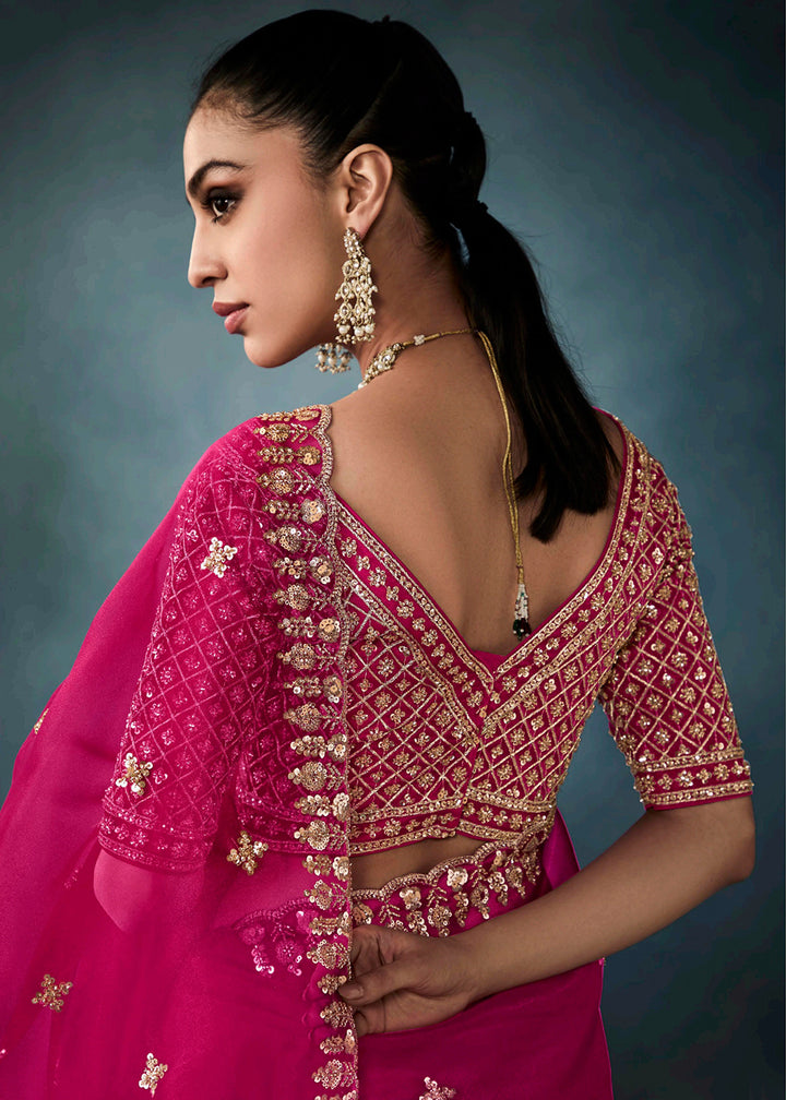 Radiant Rani Pink tissue saree with intricate handwork & cutwork embroidery. Includes matching blouse piece. Perfect for wedding & festivals. Shop Now.