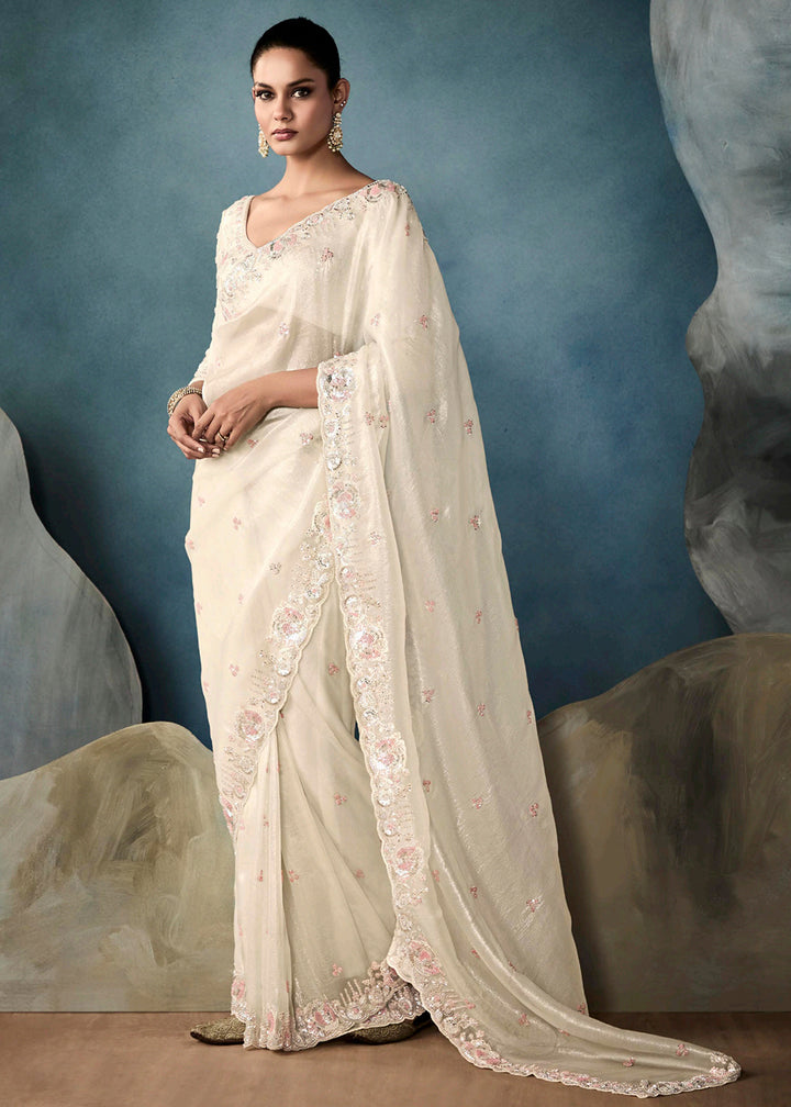 Radiant Off White tissue saree with intricate handwork & cutwork embroidery. Includes matching blouse piece. Perfect for wedding & festivals. Shop Now.