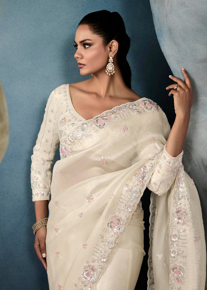 Radiant Off White tissue saree with intricate handwork & cutwork embroidery. Includes matching blouse piece. Perfect for wedding & festivals. Shop Now.