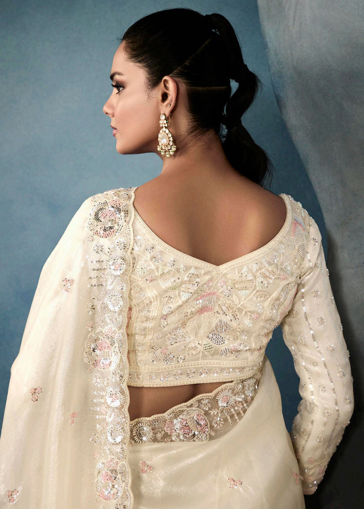 Radiant Off White tissue saree with intricate handwork & cutwork embroidery. Includes matching blouse piece. Perfect for wedding & festivals. Shop Now.