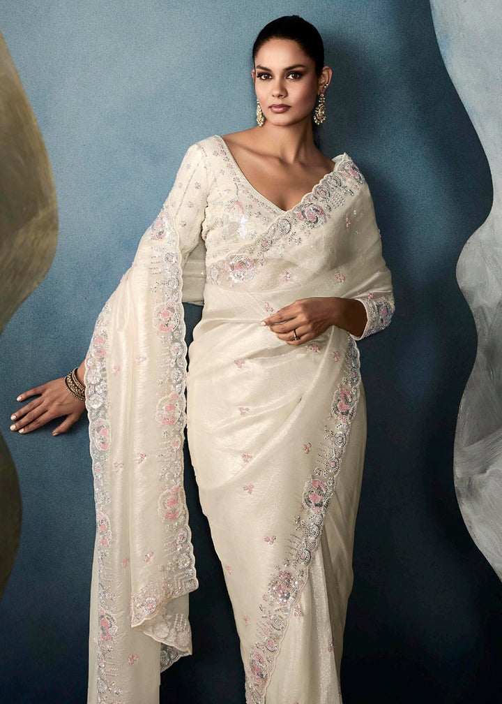 Radiant Off White tissue saree with intricate handwork & cutwork embroidery. Includes matching blouse piece. Perfect for wedding & festivals. Shop Now.