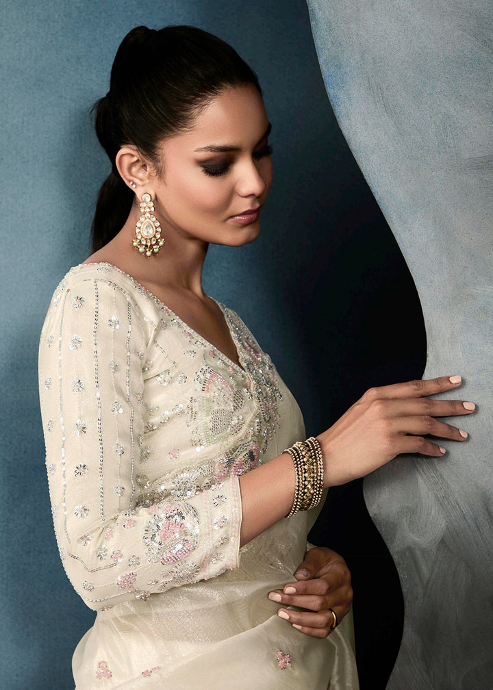 Radiant Off White tissue saree with intricate handwork & cutwork embroidery. Includes matching blouse piece. Perfect for wedding & festivals. Shop Now.