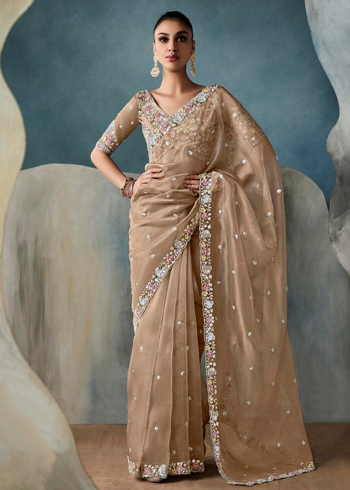 Radiant Beige tissue saree with intricate handwork & cutwork embroidery. Includes matching blouse piece. Perfect for wedding & festivals. Shop Now.