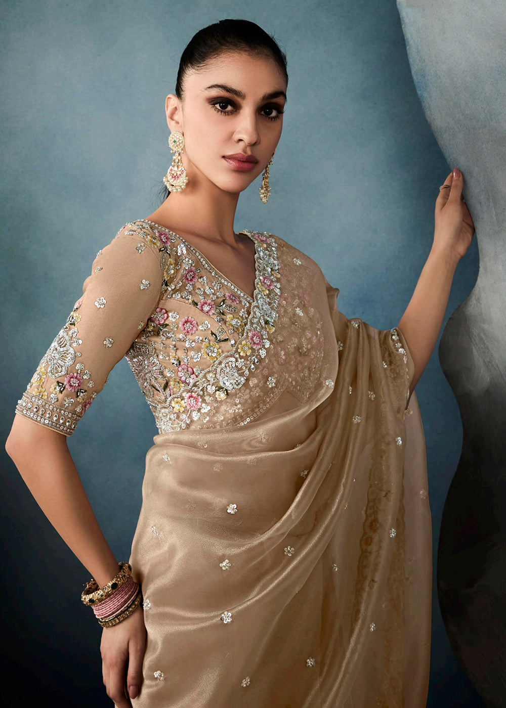 Radiant Beige tissue saree with intricate handwork & cutwork embroidery. Includes matching blouse piece. Perfect for wedding & festivals. Shop Now.