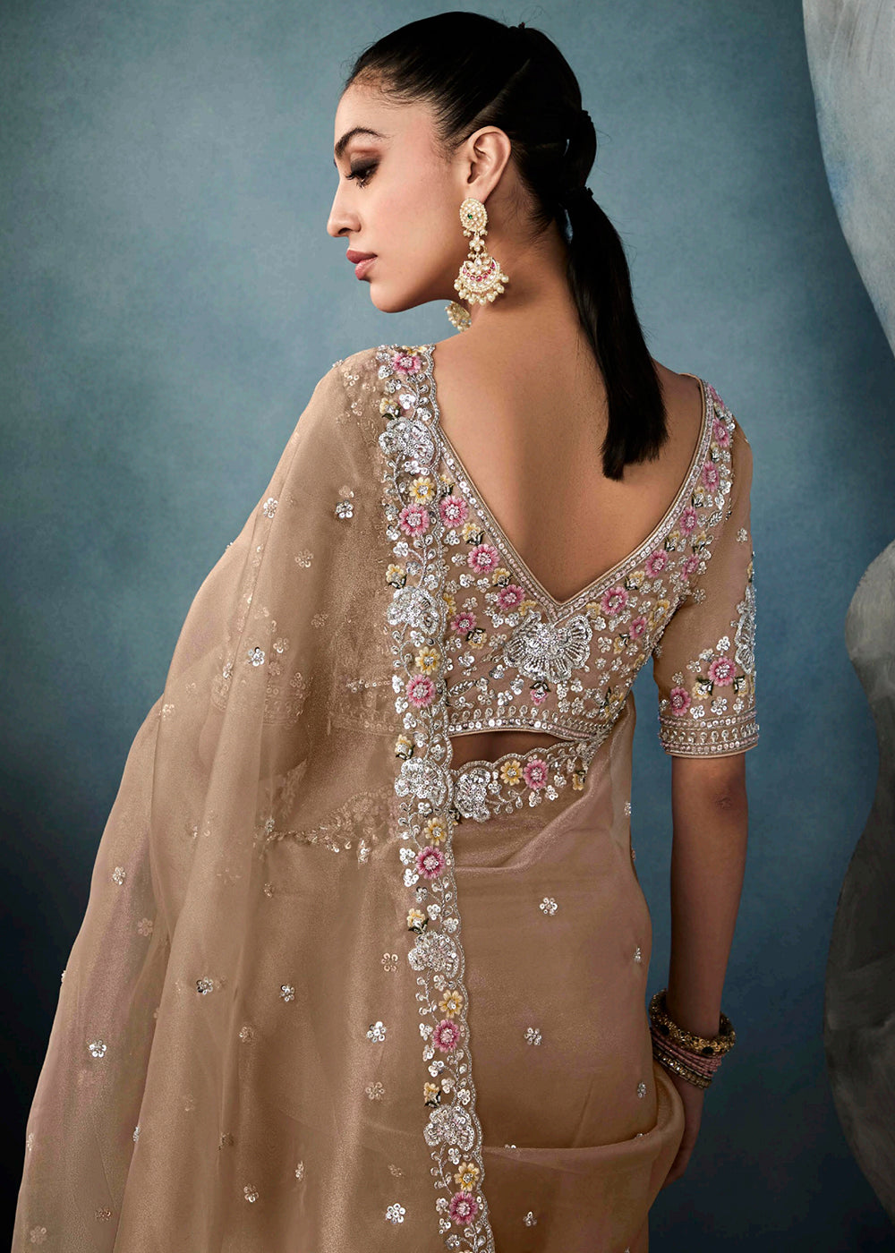 Radiant Beige tissue saree with intricate handwork & cutwork embroidery. Includes matching blouse piece. Perfect for wedding & festivals. Shop Now.