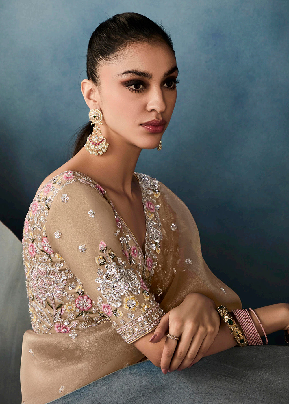 Radiant Beige tissue saree with intricate handwork & cutwork embroidery. Includes matching blouse piece. Perfect for wedding & festivals. Shop Now.