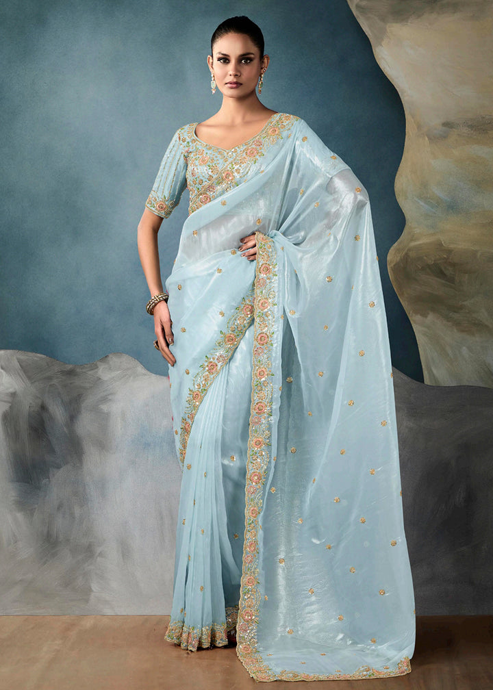 Radiant Blue tissue saree with intricate handwork & cutwork embroidery. Includes matching blouse piece. Perfect for wedding & festivals. Shop Now.