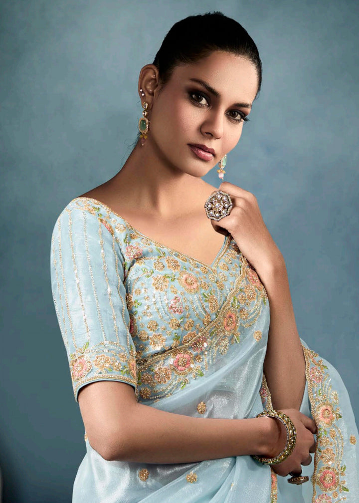 Radiant Blue tissue saree with intricate handwork & cutwork embroidery. Includes matching blouse piece. Perfect for wedding & festivals. Shop Now.